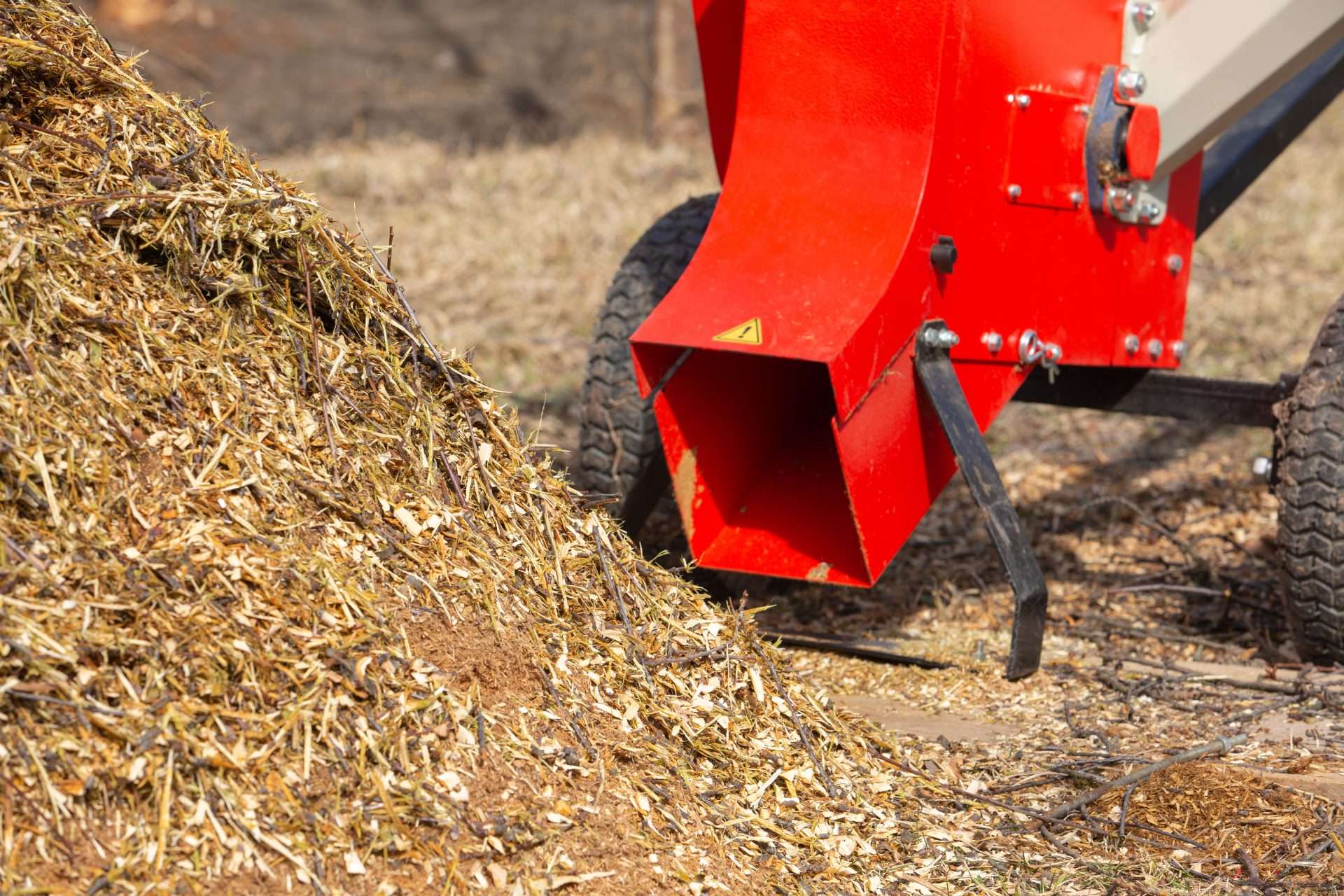 Garden shredder. A pile of wood chips with a branch crusher. Mulch bark for decoration and weed control.